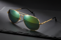 Luxury men's gold aviator sunglasses with green mirror lenses